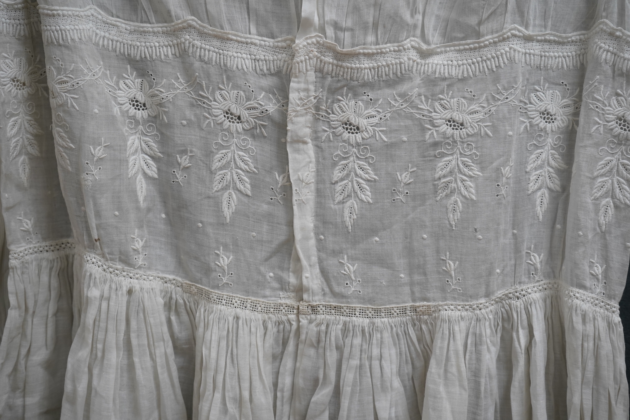 Two late 19th early 20th century girls summer dresses, one fine cotton with white worked collar cuffs and bodice, the other a cotton twill with anglaise collar large puff sleeves and gathered across the chest, lawn dress